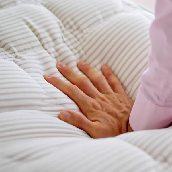 Happy-Sleeper-Hand-testing-memory-foam-mattress